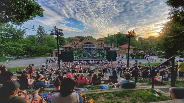 Performance happening on an outdoor stage in the evening