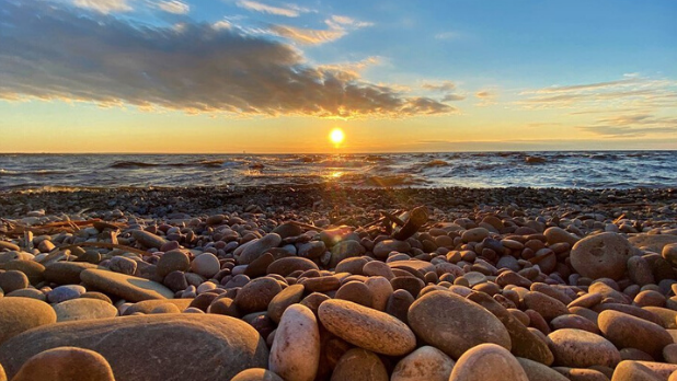 The rocky shore and sunset at Selkirk Shores State Park