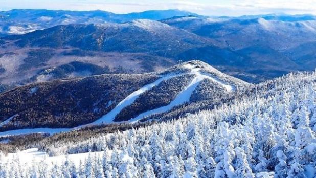 Snow covered pine trees and trails seen from above on Whiteface mountain