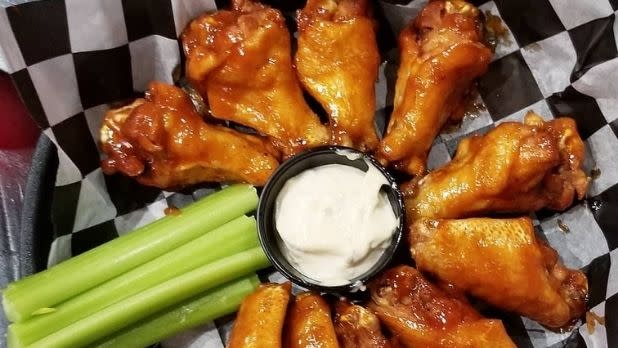Buffalo wings with dipping sauce and celery sticks
