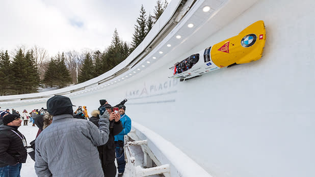Spectators watch athletes compete at the BMW IBSF Bobsled and Skeleton World Cup in Lake Placid