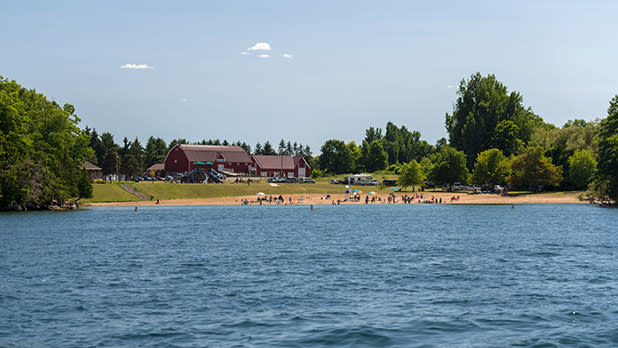 A view of the beach from across the water at Wellesley Island State Park