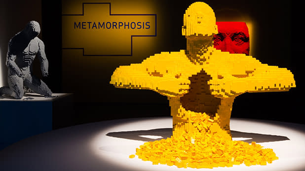 Sculpture of a man made of yellow Lego bricks at The Art of the Brick exhibit