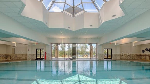 Large blue indoor pool with a skylight window