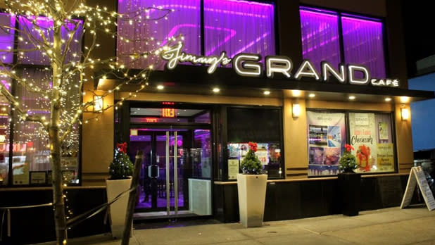 The exterior of Jimmy's Grand Cafe with purple interior lighting visible