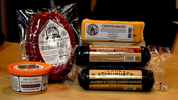 A selection of cheddaroni cheddar cheese, bologna, bacon flavored cheese spread and two sausages