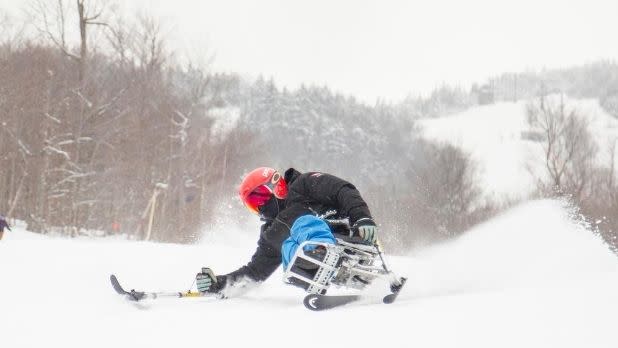 An adaptive skier in action on a snow-covered slope on Whiteface Mountain