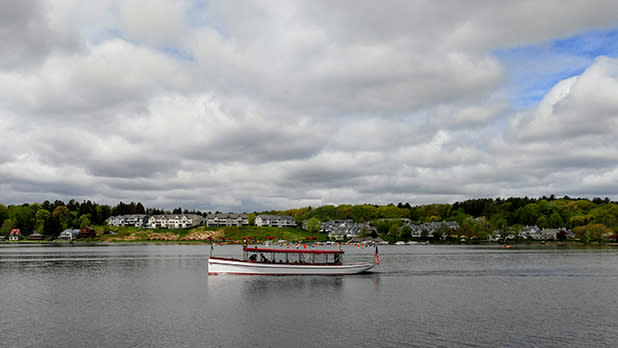 A boat with the Adirondack Cruise and Charter Company sailing through Saratoga Lakea scenic tour