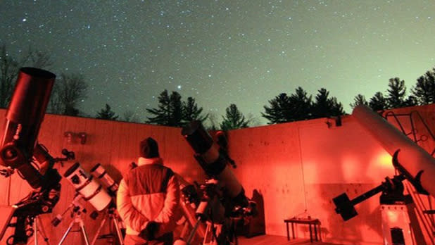 People look up at the sky to observe the starry night at the Adirondack Sky Center and Observatory