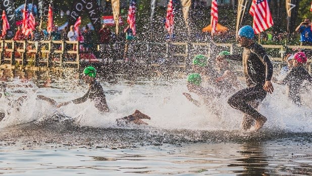 Athletes running into the water at Ironman Lake Placid