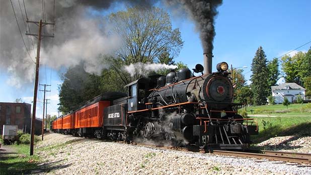 Black steam train with orange carriages