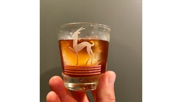 A bold fashioned cocktail held up by a hand