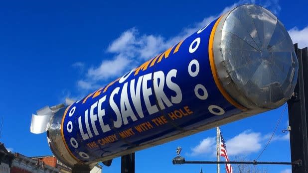 A giant roll of mint life savers on the side of the road