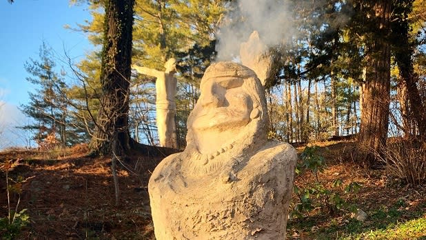 Smoke rises from the top of a specially-designed sculpture at the Brunel Sculpture Garden