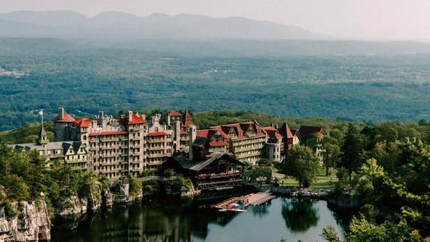 view of Mohonk Mountain House in summer with mountains in the background