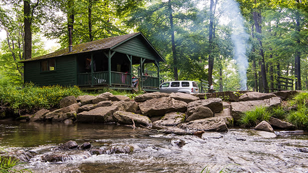 view of a cabin at allegany state park with a campfire lit out front