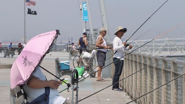 People fishing off of pier