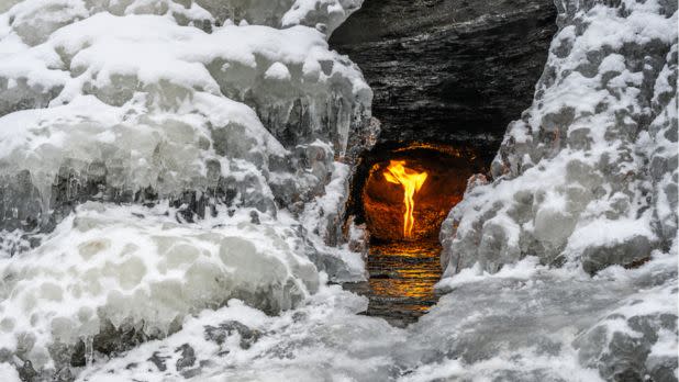 Flame burning within a frozen waterfall