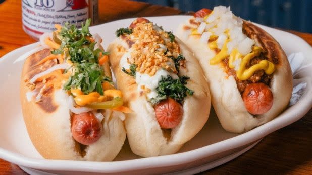Plate of mini hot dogs with various toppings