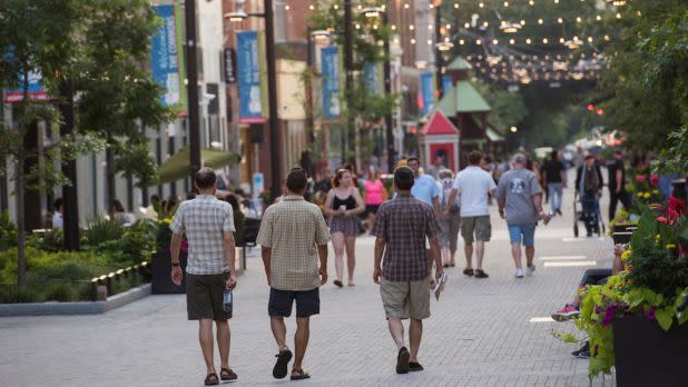 3 men walking down Ithaca Commons