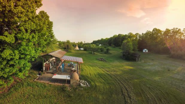 Ranch in a field at sunset