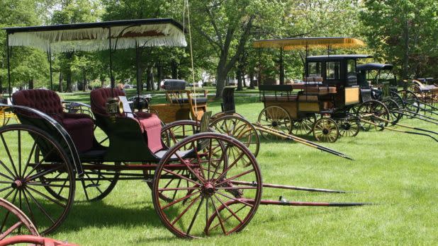 Old carriages on grass field