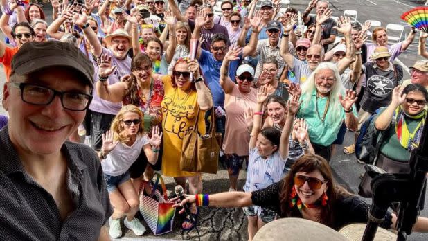 A group of people celebrating Pride to live music