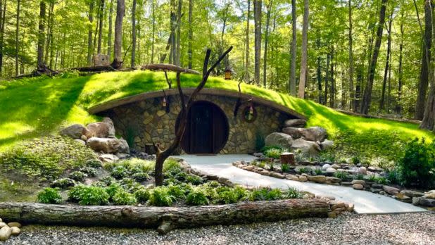 Shire-inspired hobbit house airbnb set against lush greenery