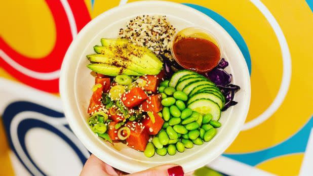 Colorful bowl of food: edamame, cucumbers, avocado, quinoa, and more vegetables