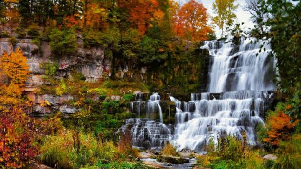 cascading waterfall surrounded by colorful fall foliage