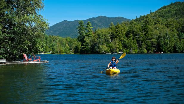 Woman kayaking on Mirror Lake in Lake Placid