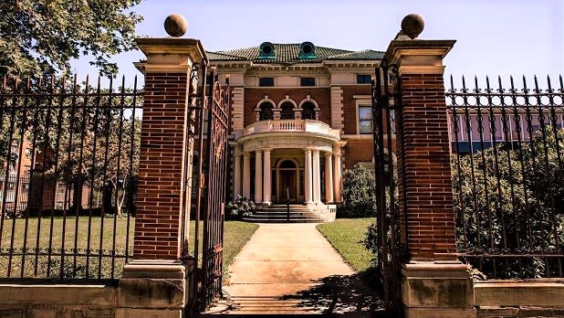 A wrought iron gate opens onto the pathway to the Roberson Museum and Science Center