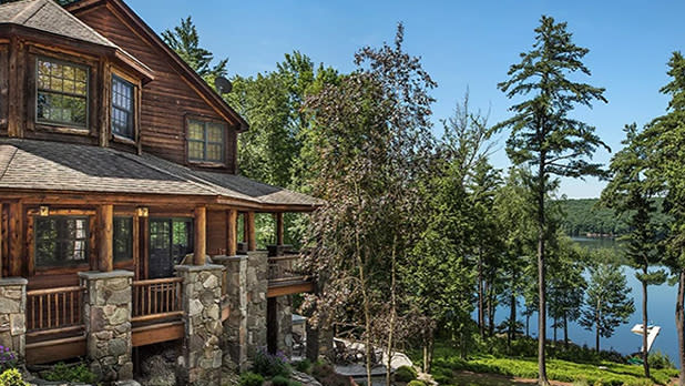 View of the wooden Chatwal Lodge next to the lake on a clear sunny day in summer