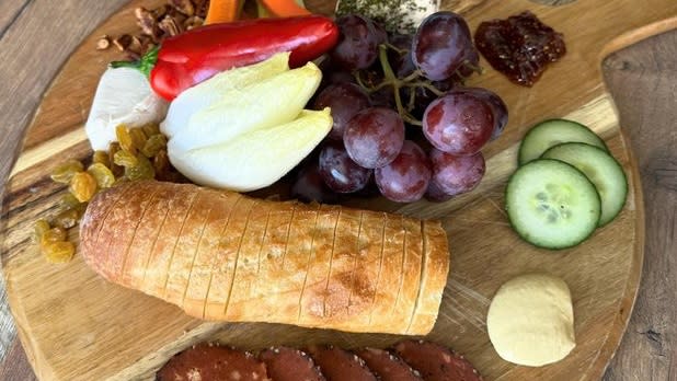 Plate of meats, chesses, fruits, and vegetables