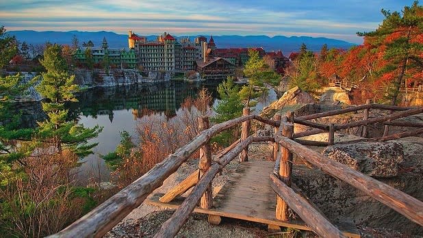Mohonk Mountain House looms over Mohonk Lake as the leaves change colors on the surrounding hills