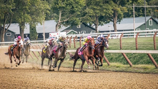 A group of jockeys riding horses at the Saratoga Race Track