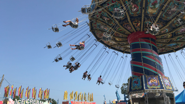 People sitting on swings fly through the air at the Dutchess County Fair in the Hudson Valley