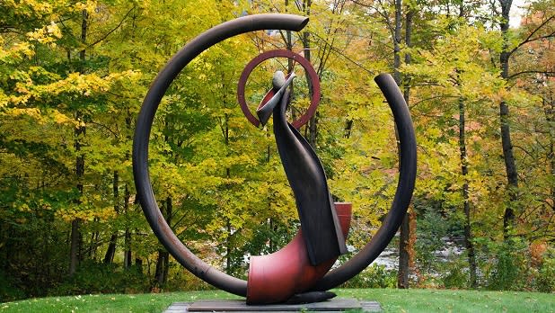 A large curved sculpture stands at Sacandaga River Sculpture Park in the Adirondacks