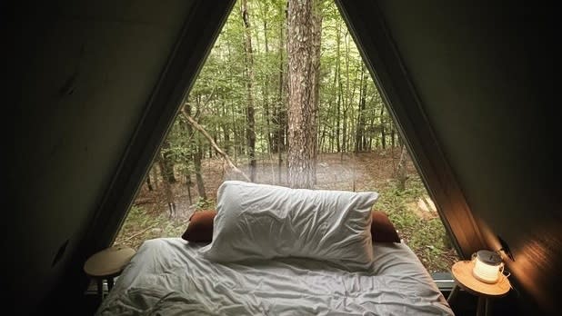 View out the window from the bed of an A-Frame cabin