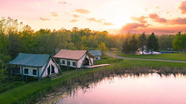 Campsites around a lake at sunset