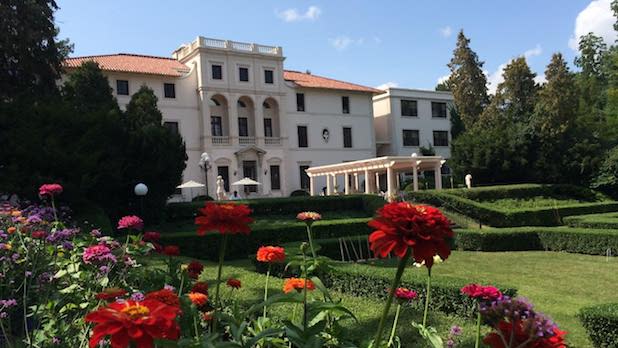 exterior of a European-inspired mansion and gardens