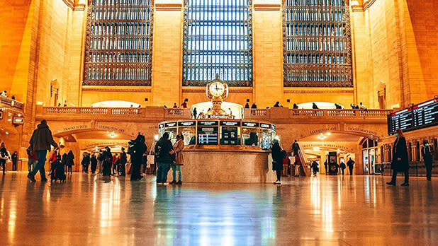 Several people walking through the halls of Grand Central Terminal