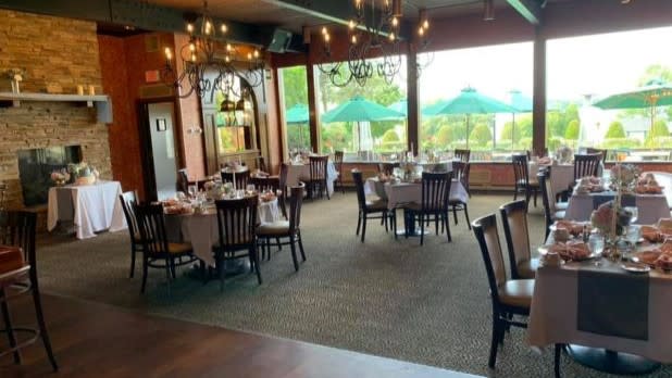 Large floor-to-ceiling windows illuminate the elegant dining room at Gran-View on the River