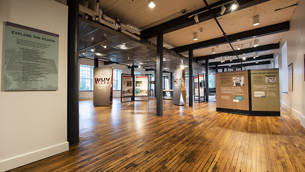 Spacious gallery with hardwood floors, featuring informative panels titled "Why" and "When Women Innovate" at the National Women’s Hall of Fame.