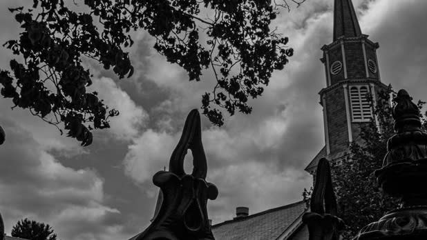 Black and white photo looking up at an old church