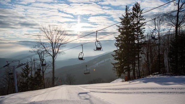View of snowy ski lift from a trail at Hunter Mountain in the Catskills Region of New York State