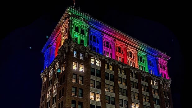 A building lit up in Pride colors in Binghamton