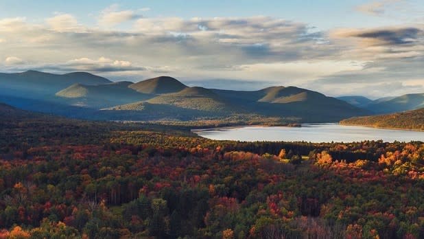 The Ashokan Reservoir surrounded by beautiful fall foliage and the Catskill Mountains