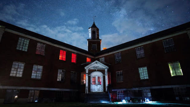 exterior of the Rolling Hills Asylum at night under a sky full of stars