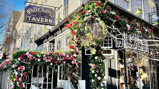 The historic White Horse Tavern exterior lavishly decorated in spring flowers in Greenwich Village
